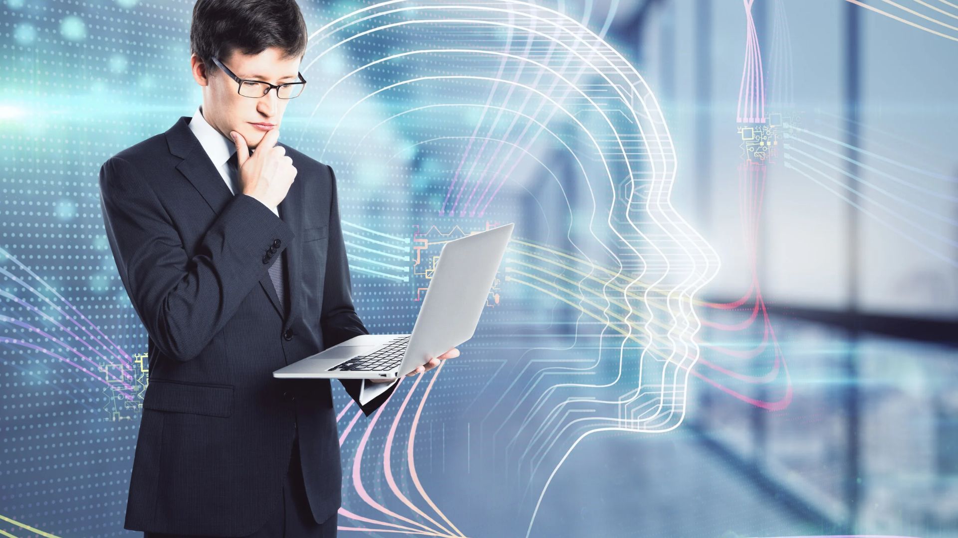 Professionista con computer portatile in ufficio accanto a un volto stilizzato che rappresenta l'intelligenza artificiale